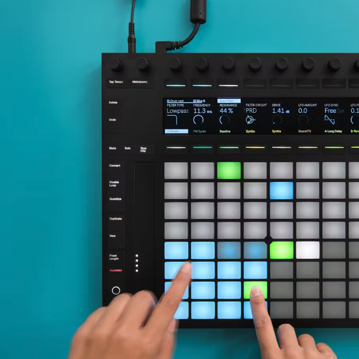 Hands playing an Ableton Push controller